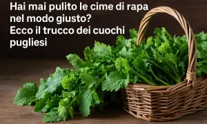 Cesto di vimini pieno di fresche cime di rapa, pronte per essere cucinate secondo il segreto dei cuochi pugliesi.