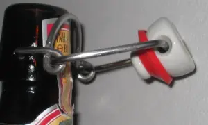 La bottiglia che si stappa da sola, con il suo tappo a scatto in ceramica bianca e rossa, evoca un senso di attesa e liberazione.