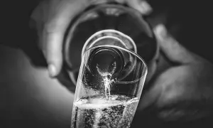 Versando bollicine in un bicchiere, un brindisi che evoca il metodo Charmat.
