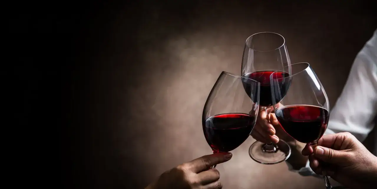 Un brindisi con calici di vino rosso, un momento di gioia e condivisione.